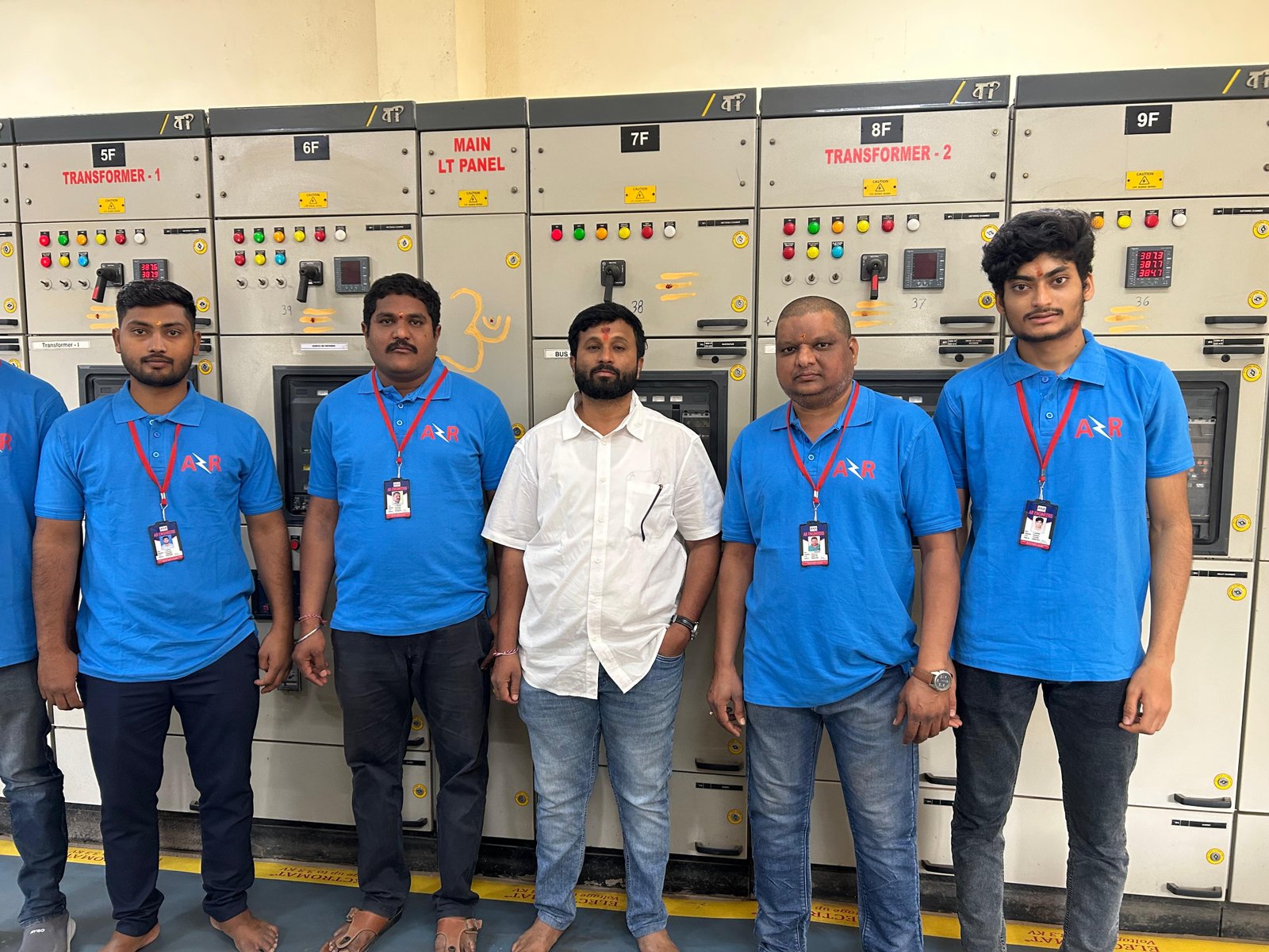 AR Engineers team standing between essential panel switchgear during a site visit
