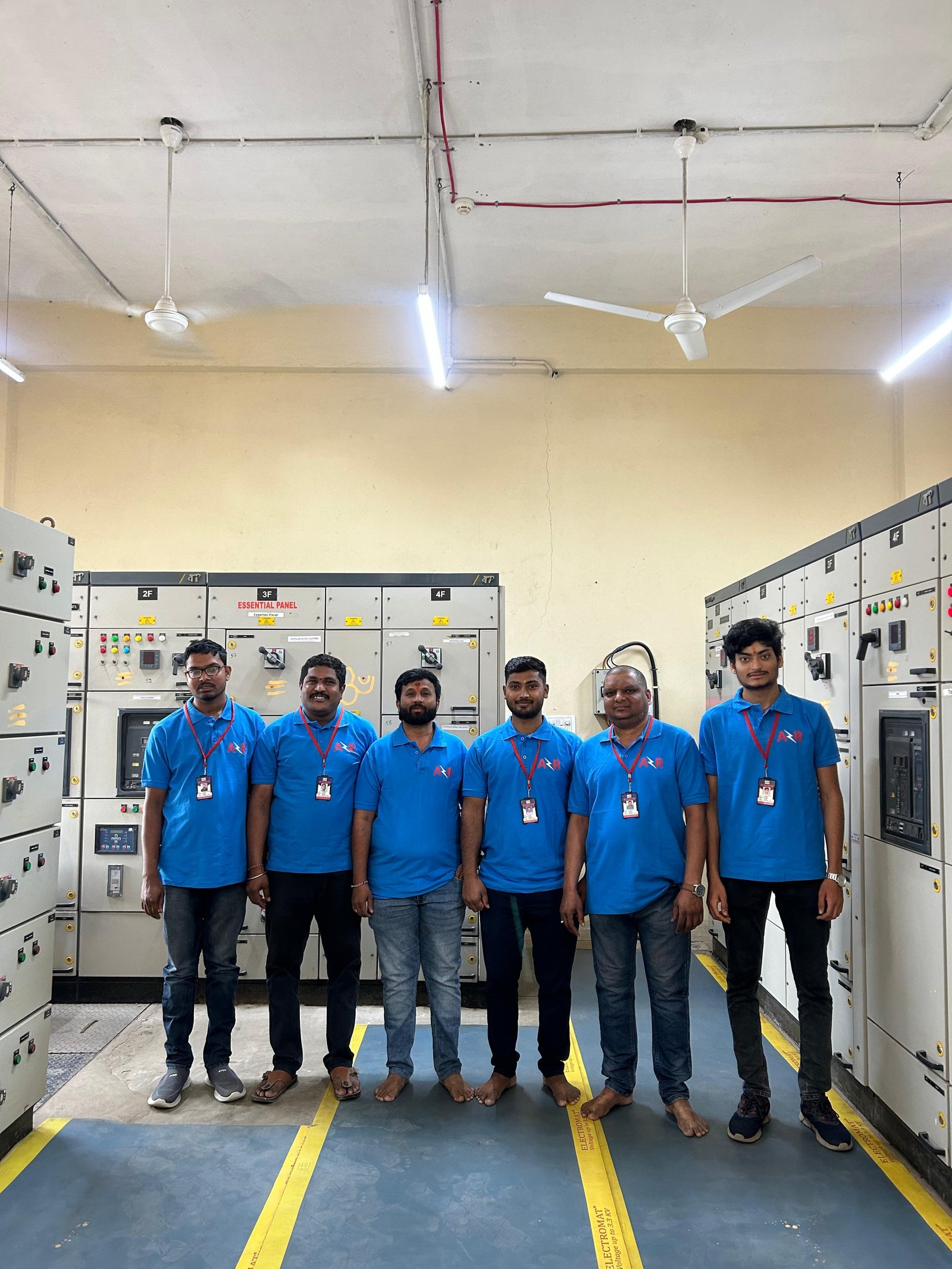 AR Engineers engineers and technicians in front of transformer panels 5F to 9F