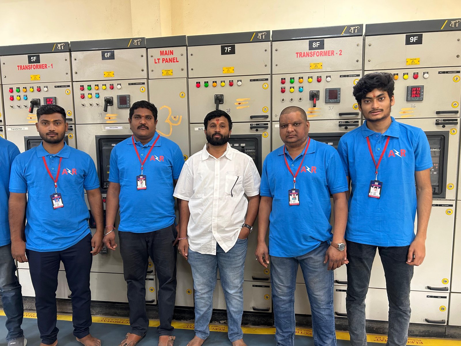 Full AR Engineers site team photographed in the electrical panel room